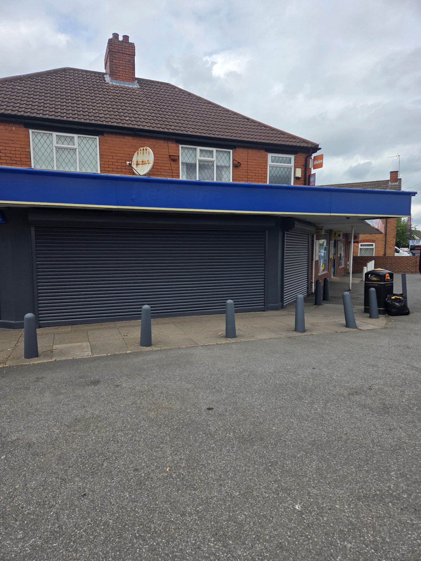 Company-supplied photograph of the completed best-one store frontage with dark grey shutters, framing and columns