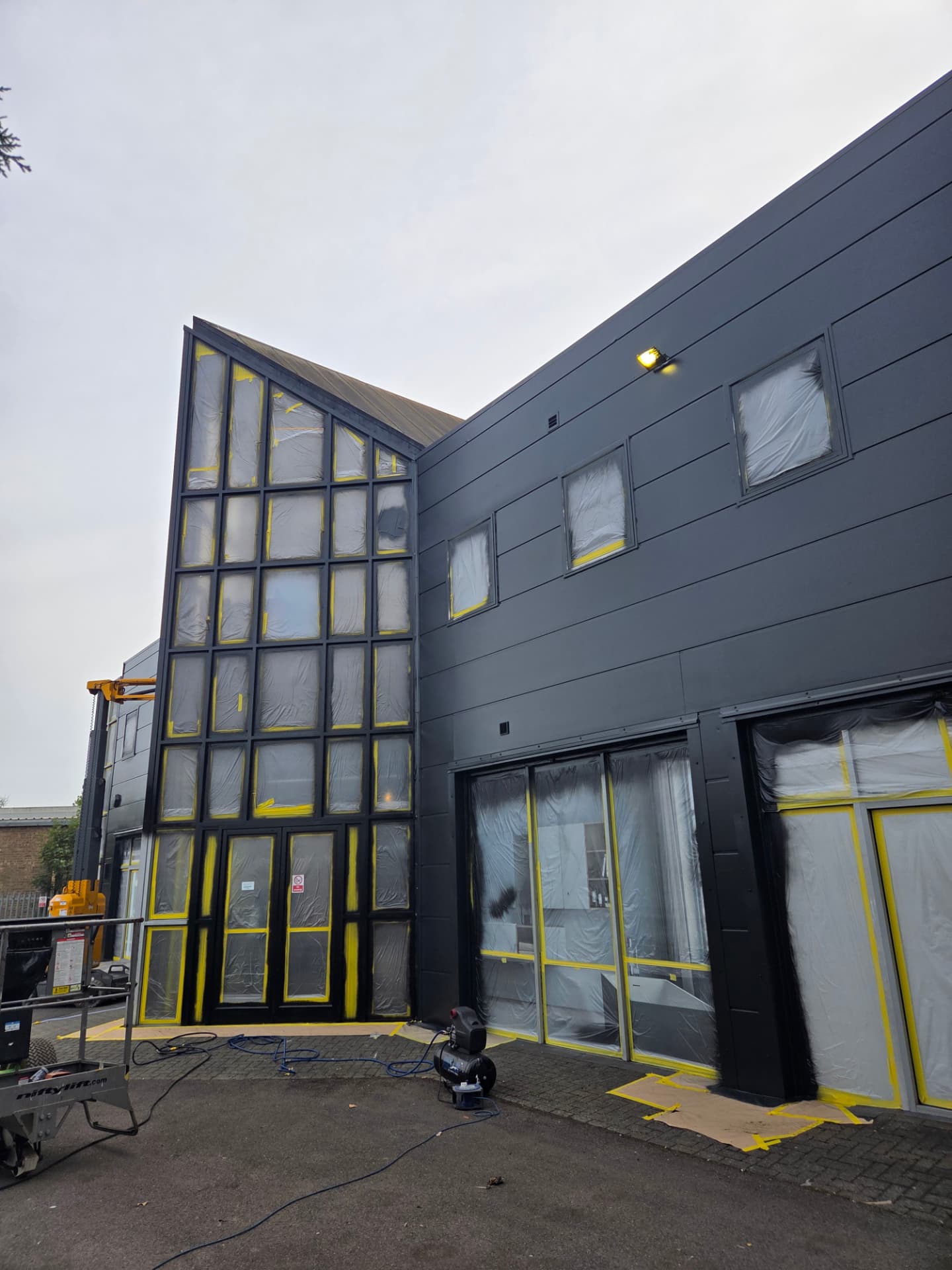 Company-supplied photograph of the showroom windows masked and protected during respraying