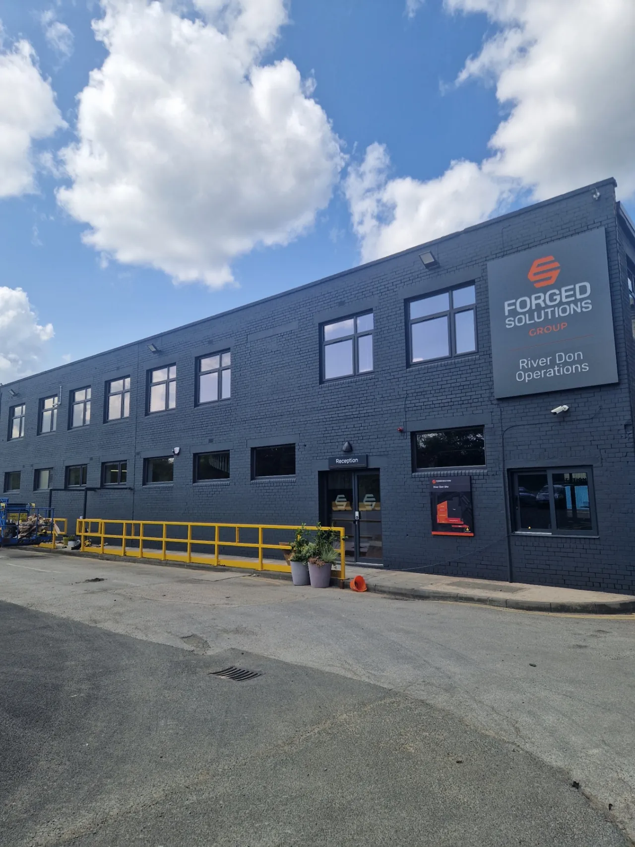 Company-supplied photograph: Resprayed anthracite grey office-block reception frontage