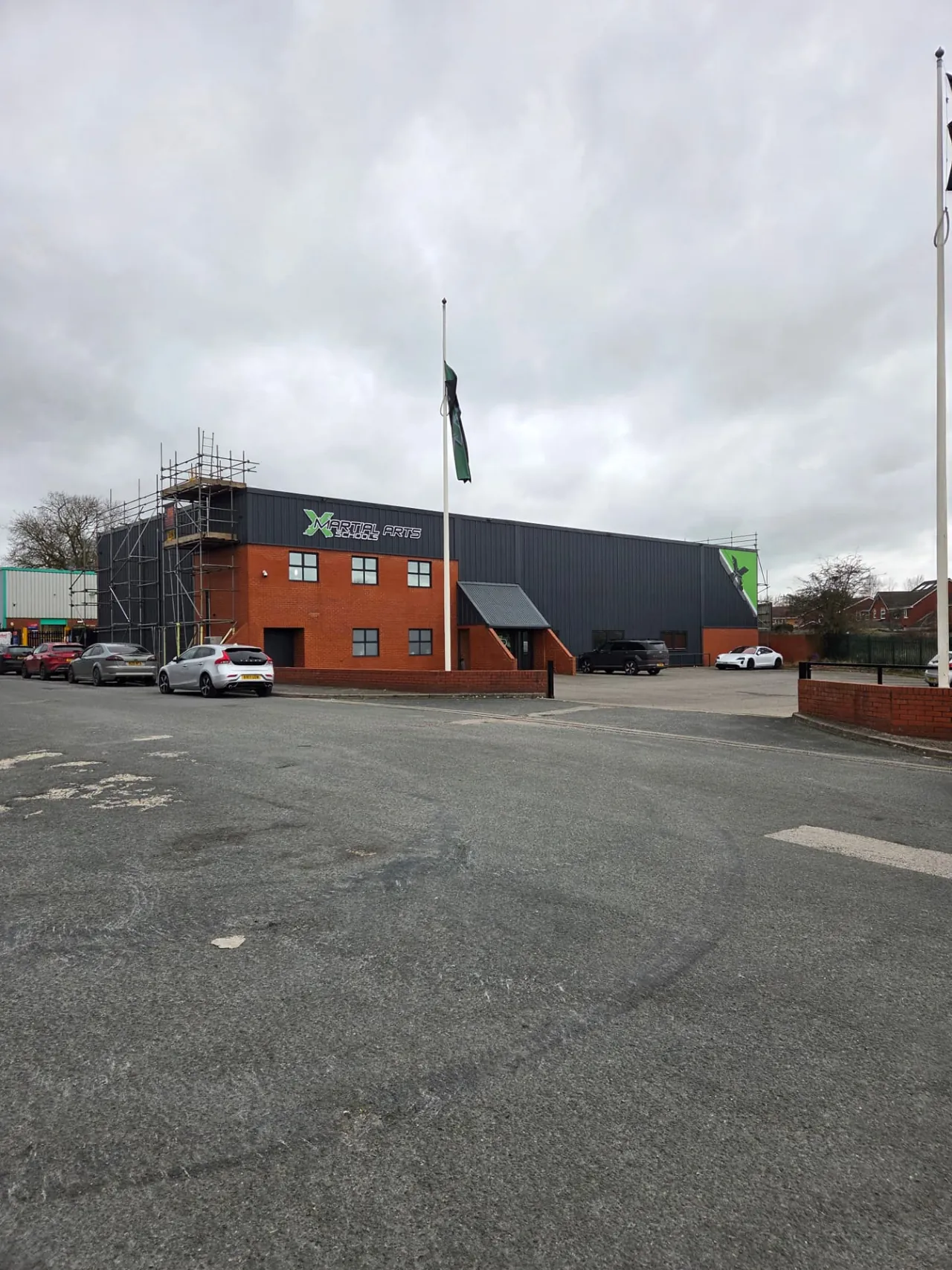 Company-supplied X Martial Arts exterior photograph with charcoal cladding and brickwork