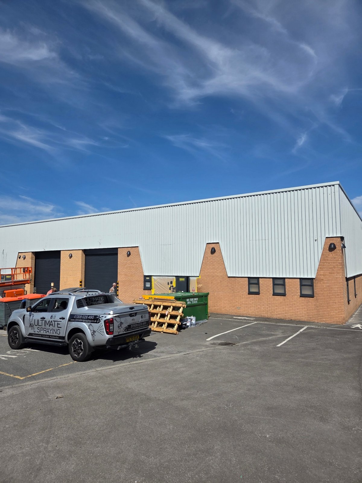 Company-supplied photograph: Bradford front elevation with light grey cladding, anthracite grey shutters and window masking remaining