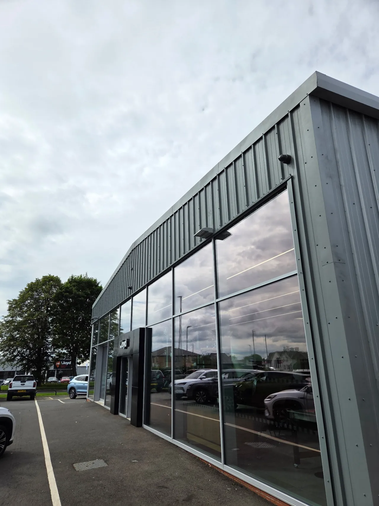 Company-supplied photograph: Completed showroom entrance and RAL 7005 mouse grey cladding