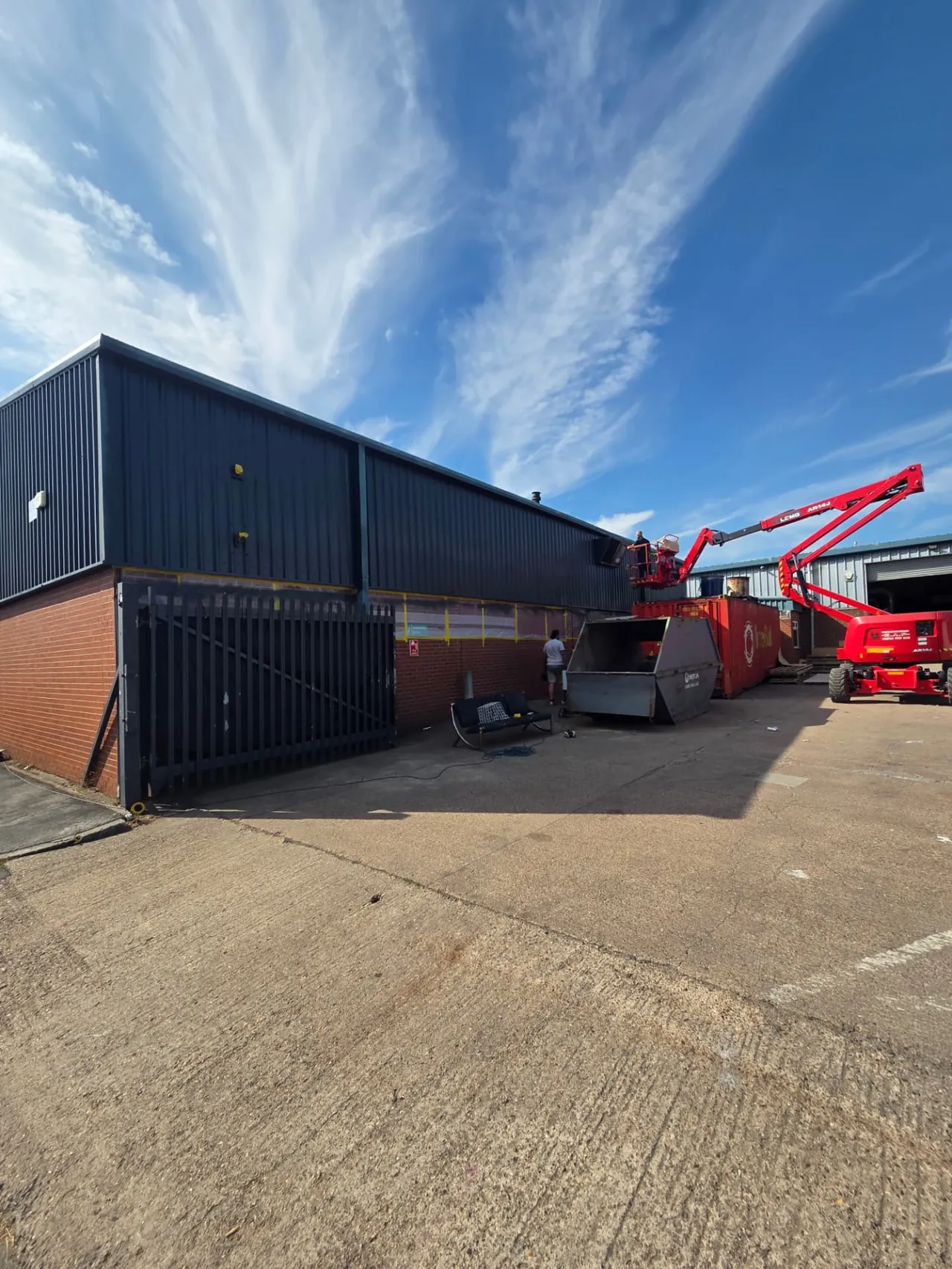 Company-supplied photograph of a factory exterior with cladding resprayed in anthracite grey and black trims