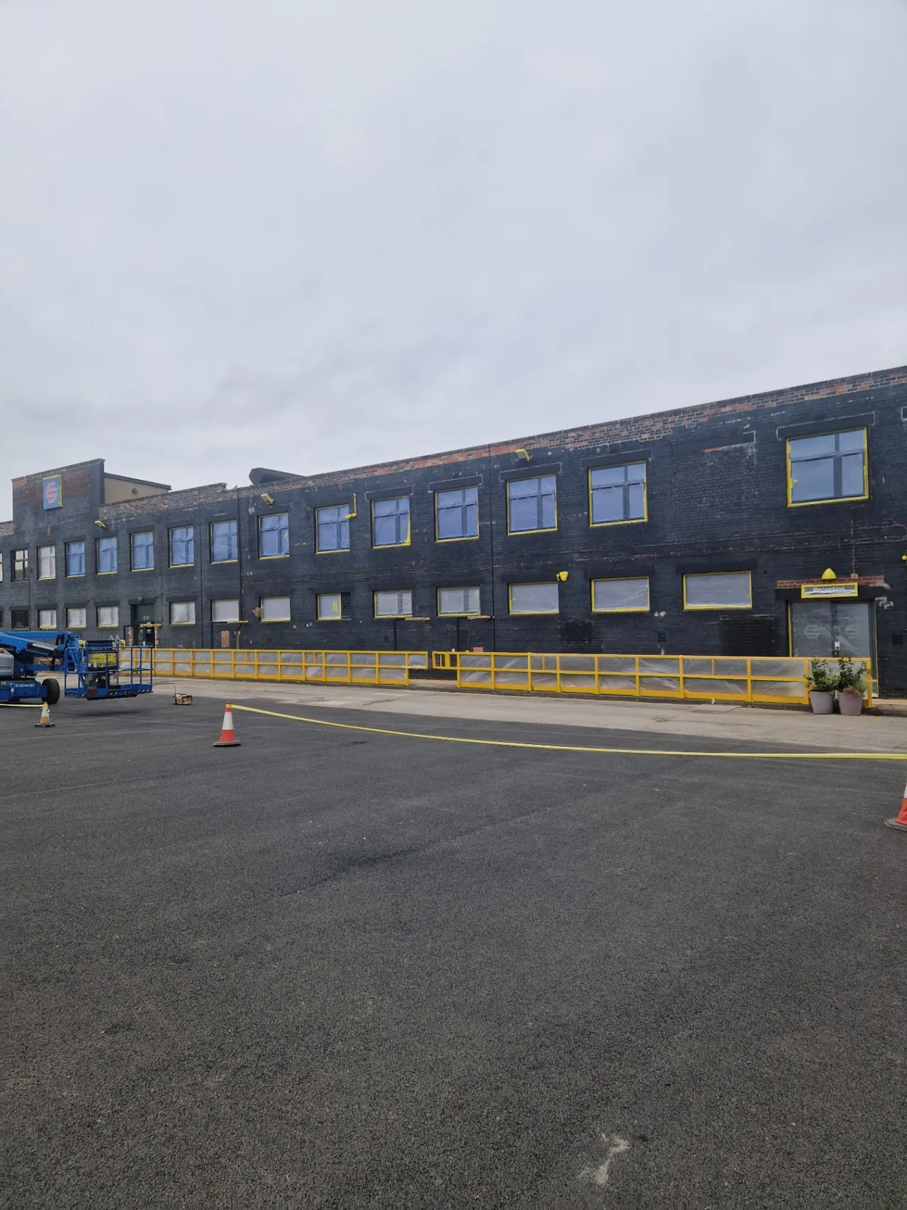 Company-supplied photograph: Office-block windows masked before respraying