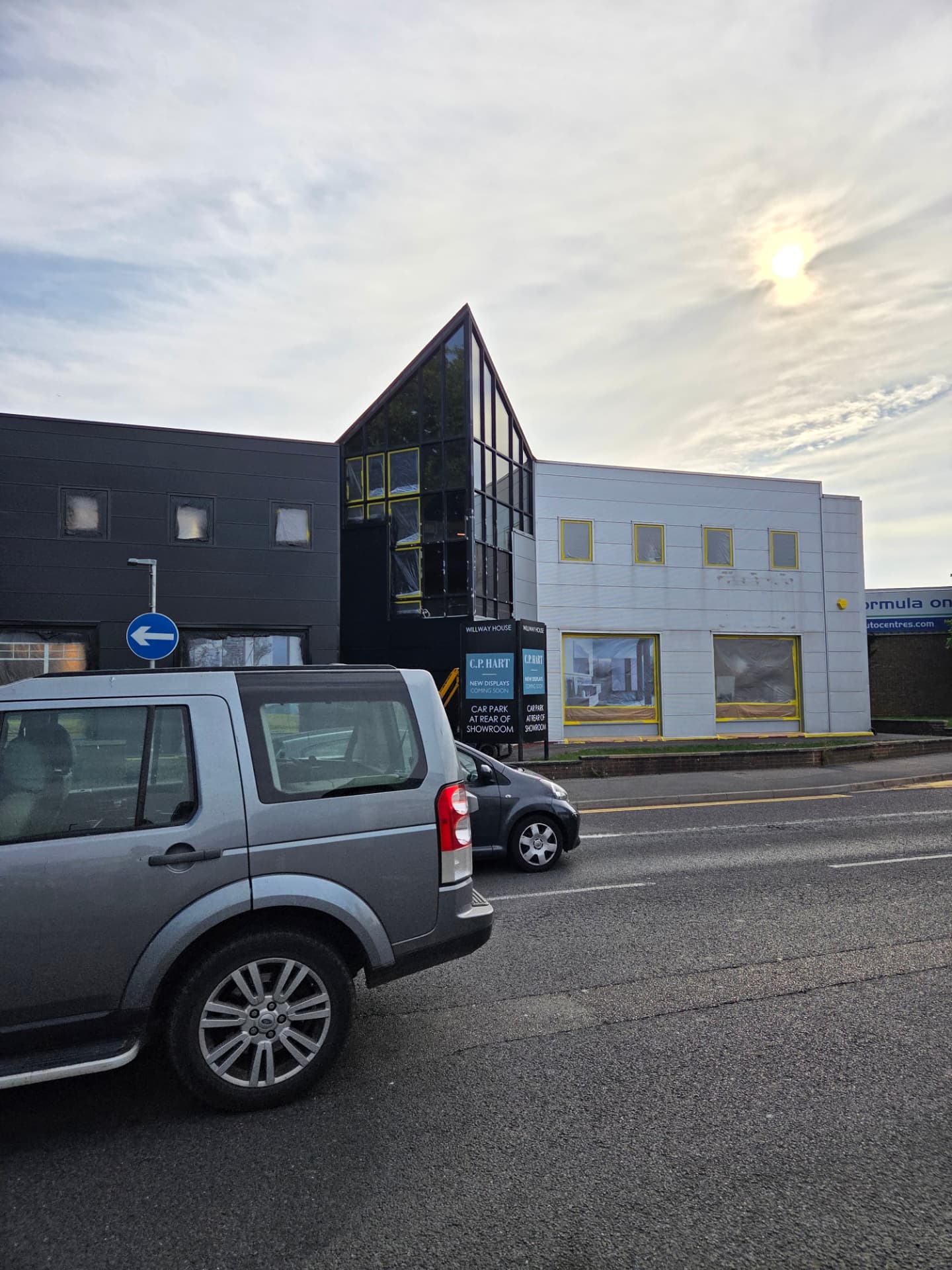 Company-supplied photograph of the showroom street elevation during the works with masked windows and access equipment