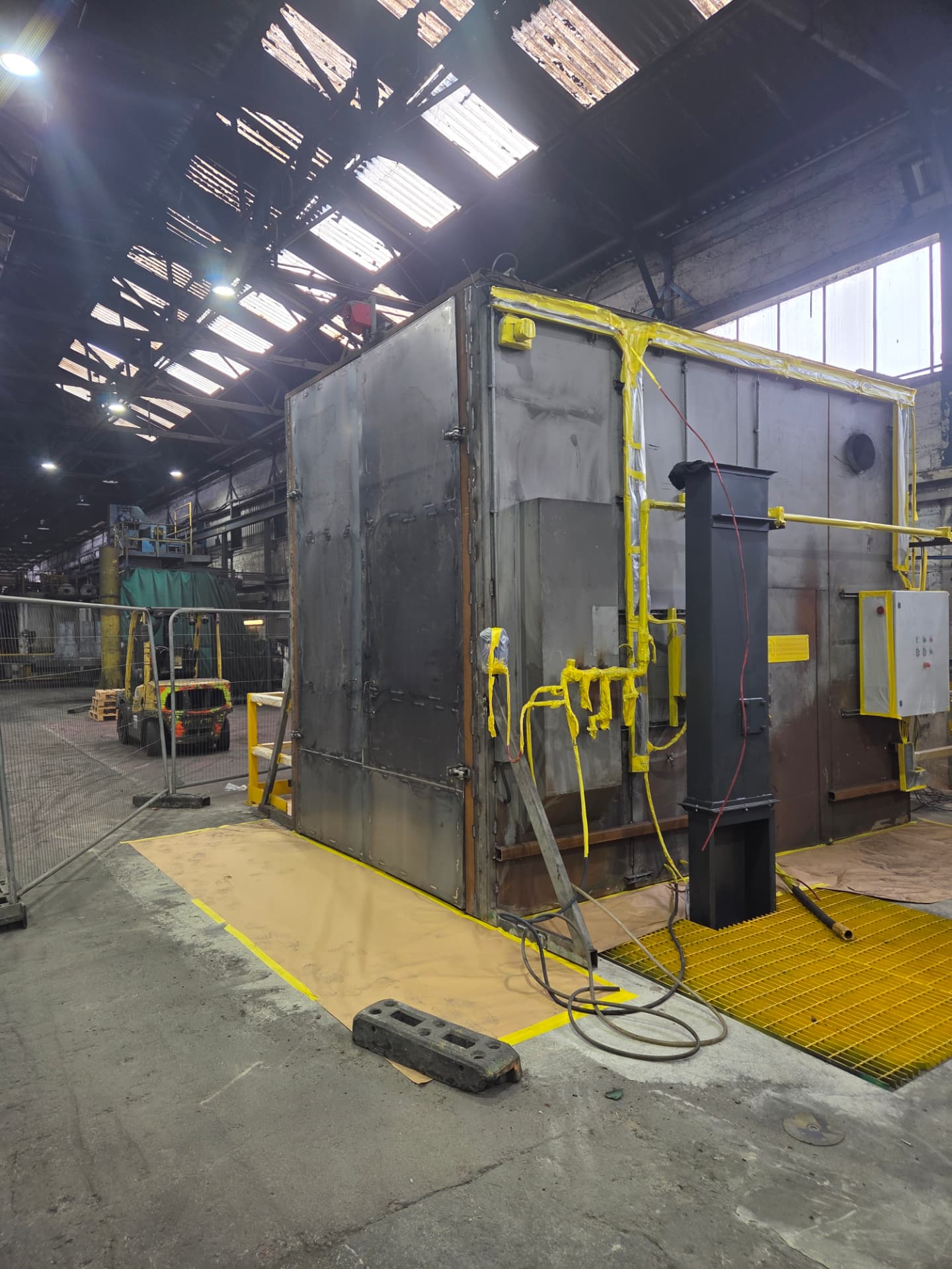 Company-supplied photograph: Forged Solutions silo and container before respraying, masked and protected during preparation