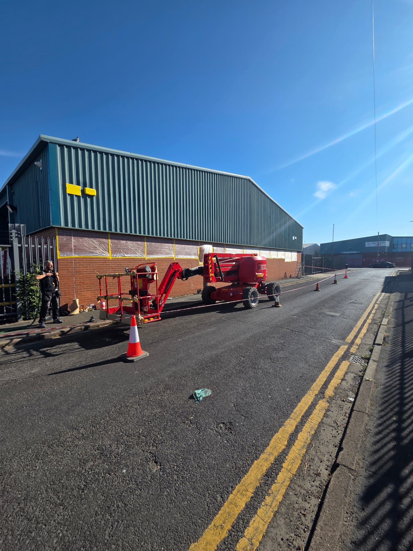 Company-supplied photograph of the factory brickwork masked and protected during preparation