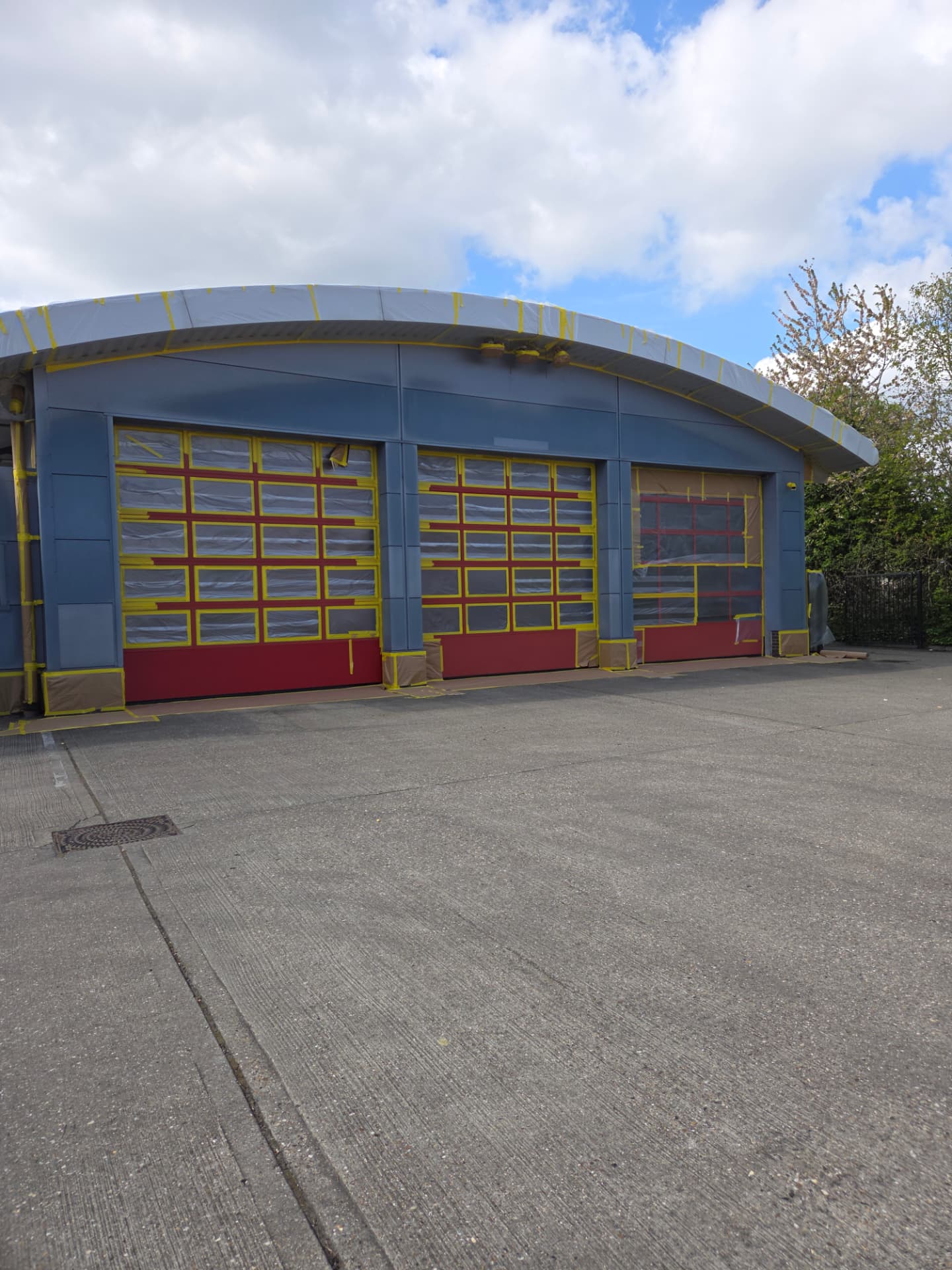 Company-supplied photograph of the fire station appliance-bay doors masked and protected during preparation