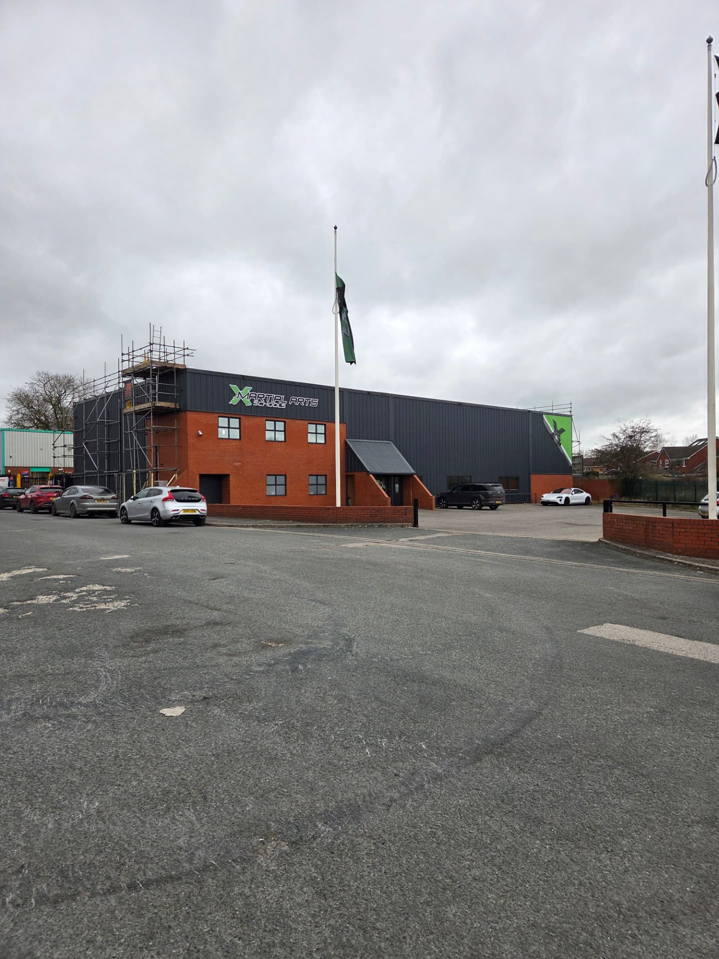Company-supplied X Martial Arts exterior photograph with charcoal cladding and brickwork