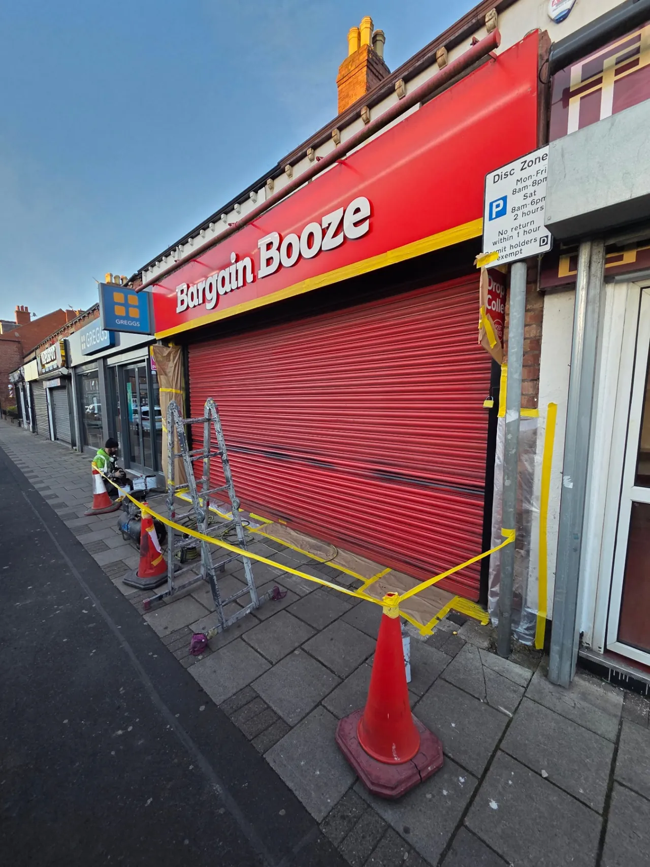 Company-supplied photograph: Company-supplied photograph of the Bargain Booze store roller shutter before respraying, masked during evening works