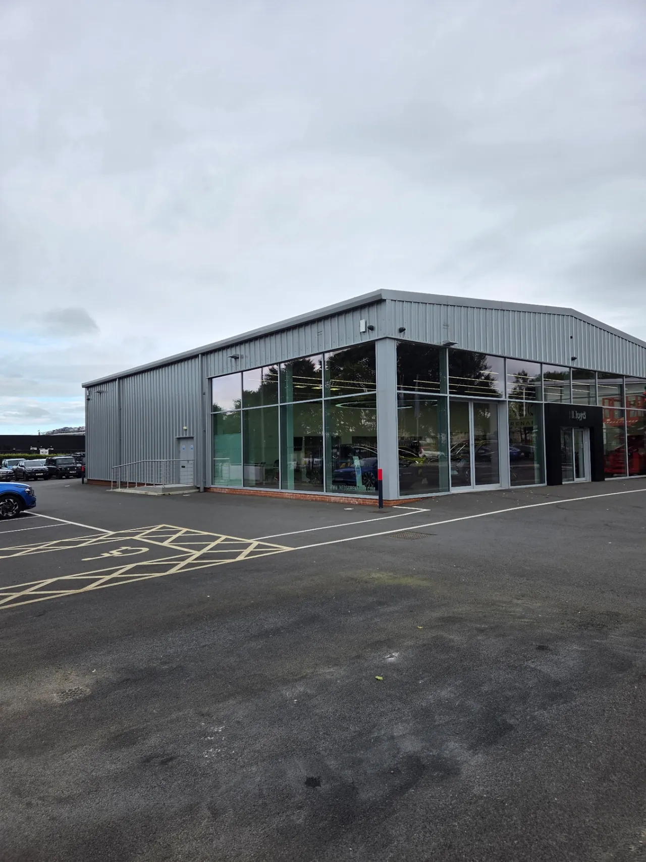 Company-supplied photograph: Lloyd/INEOS showroom corner with original light grey cladding before respraying