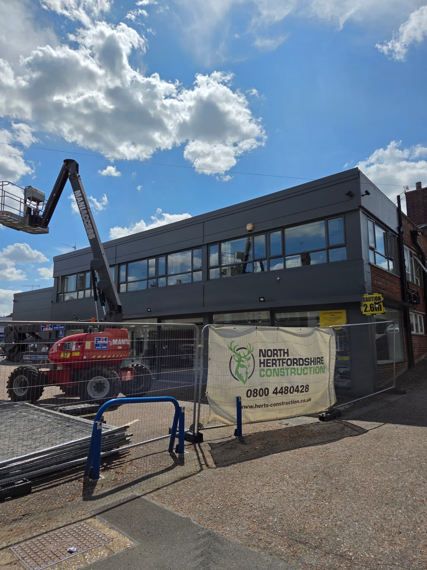 Company-supplied photograph of the Ford showroom side elevation with RAL 7005 mouse grey cladding and windows