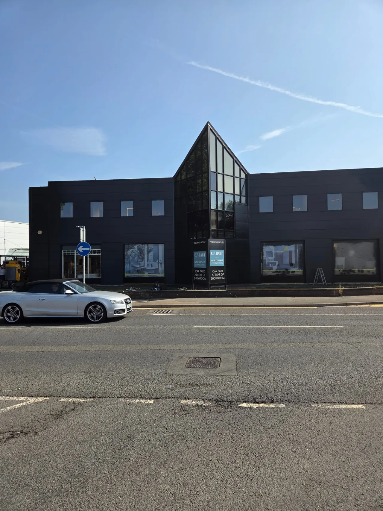 Company-supplied photograph of the completed CD Bathrooms showroom in Reading with RAL 7021 black grey cladding and RAL 9005 jet black windows and doors