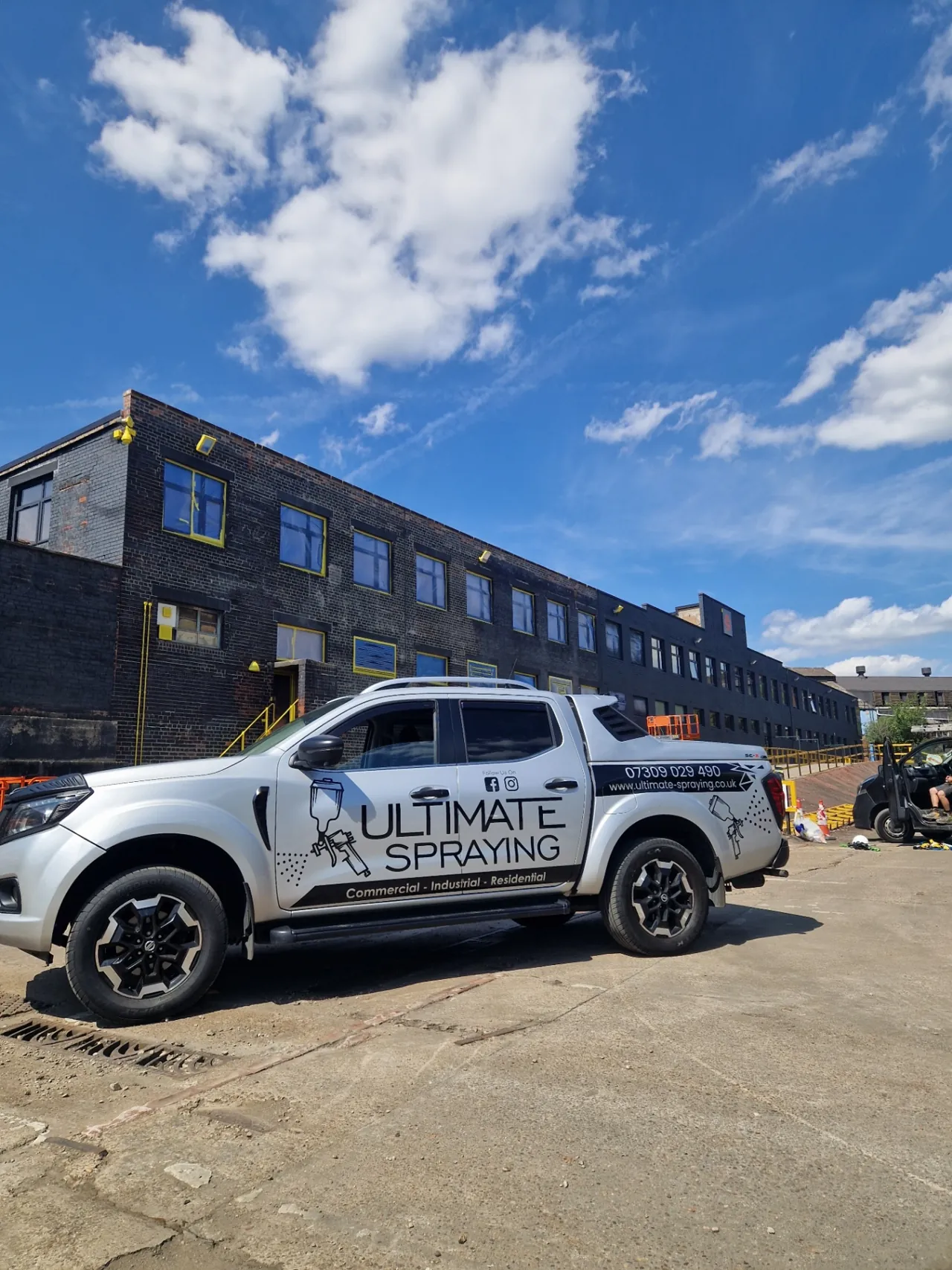 Company-supplied photograph: Ultimate Spraying vehicle beside the office block during the works