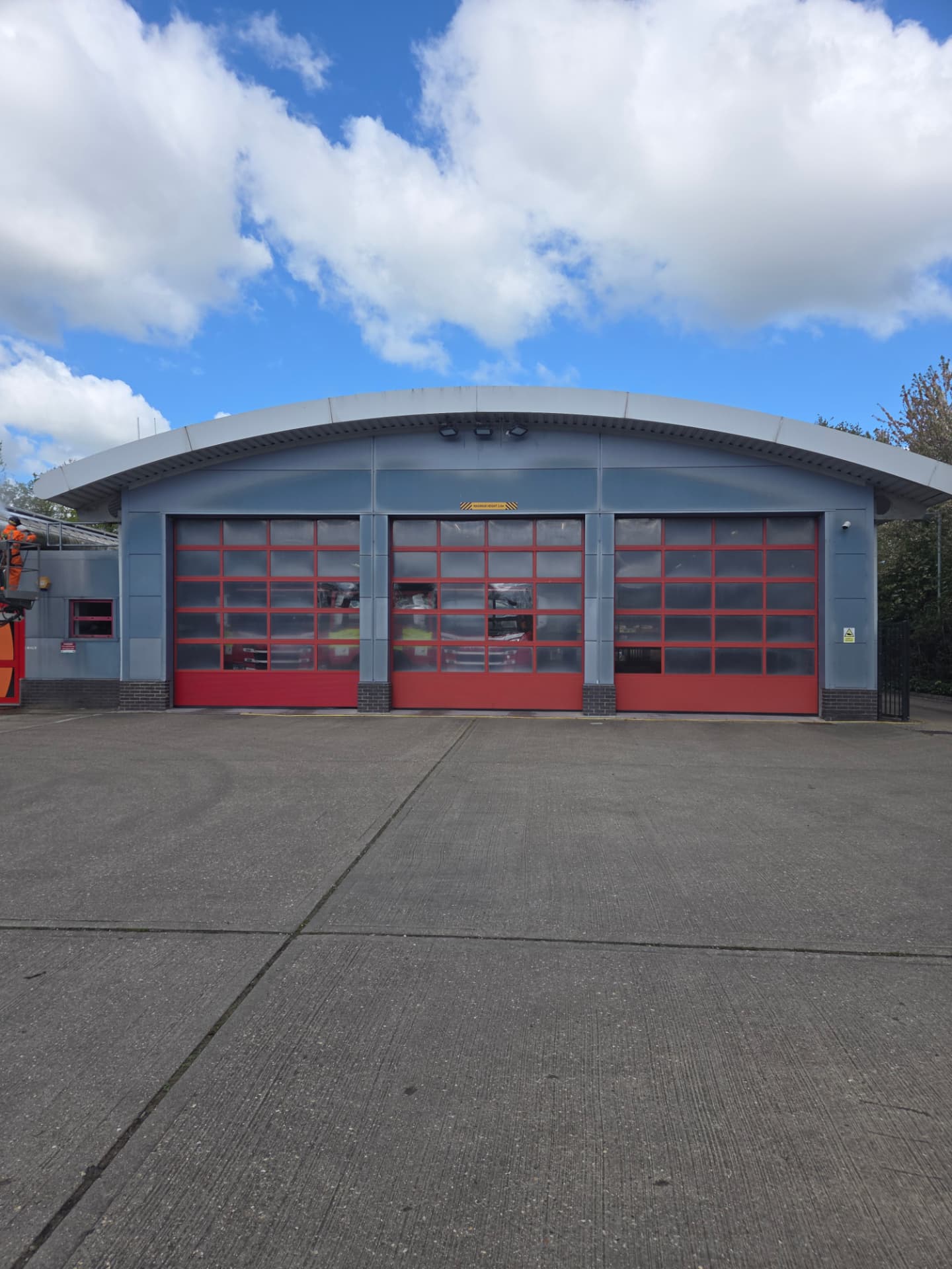 Company-supplied photograph: Company-supplied photograph of the St Albans Fire Station frontage before respraying, with the original grey panels and red appliance-bay doors