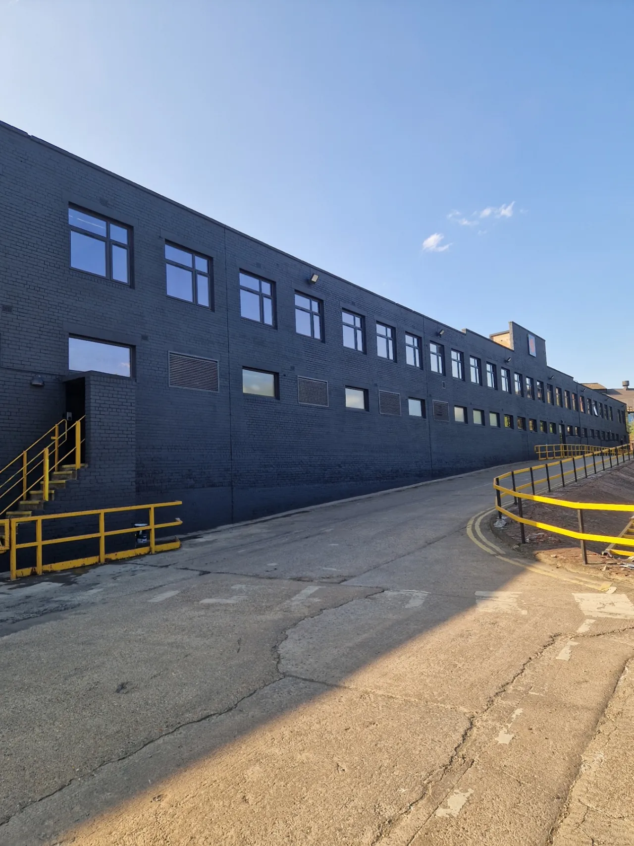 Company-supplied photograph: Completed long office-block elevation in anthracite grey