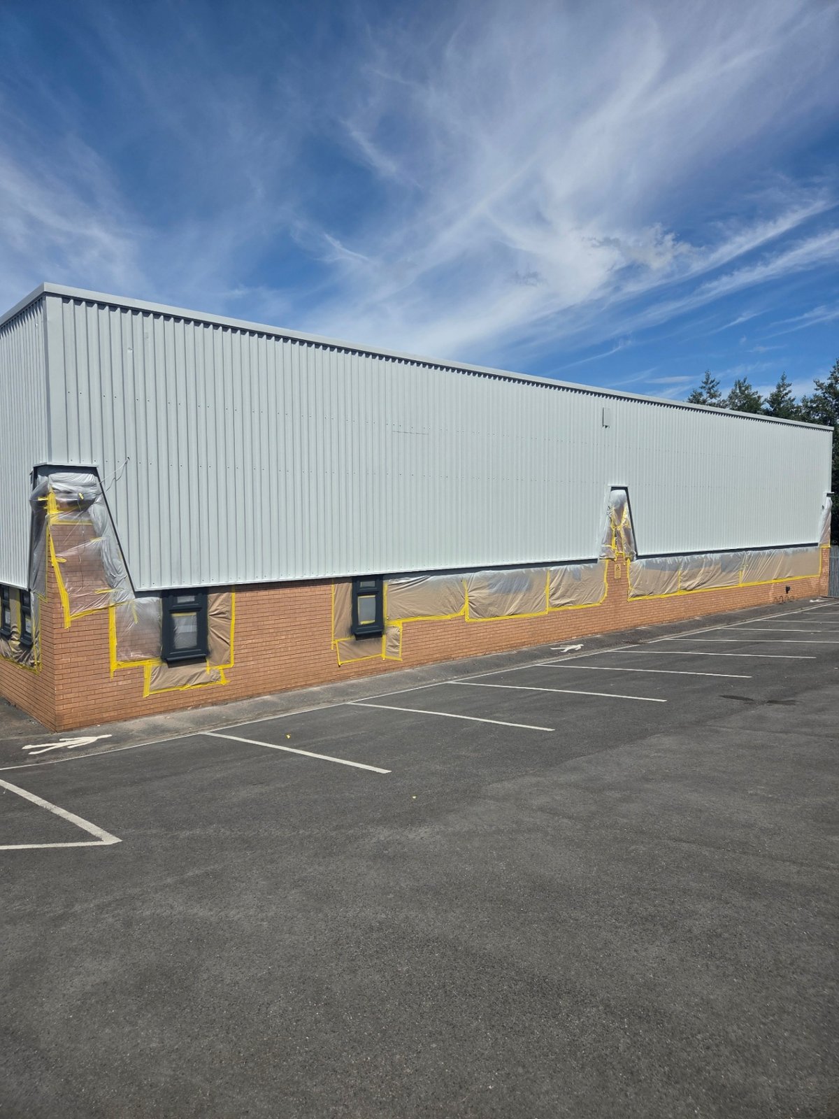 Company-supplied photograph: Bradford side elevation with light grey cladding and windows and brickwork masked