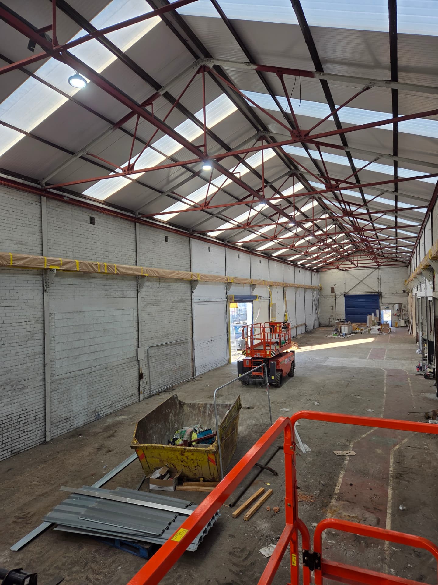 Company-supplied photograph of the Wakefield warehouse during respraying with access equipment in place