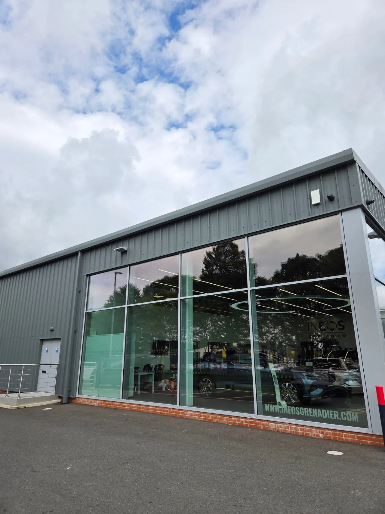Company-supplied photograph: Completed mouse grey cladding beside the INEOS showroom glazing