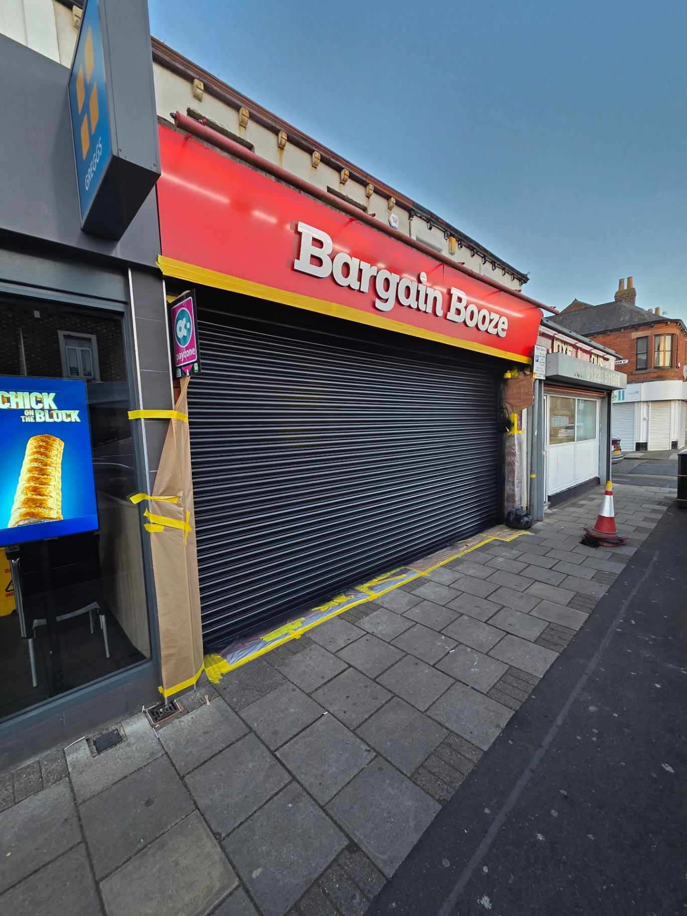 Company-supplied photograph of the completed Bargain Booze roller shutter resprayed in black during evening works