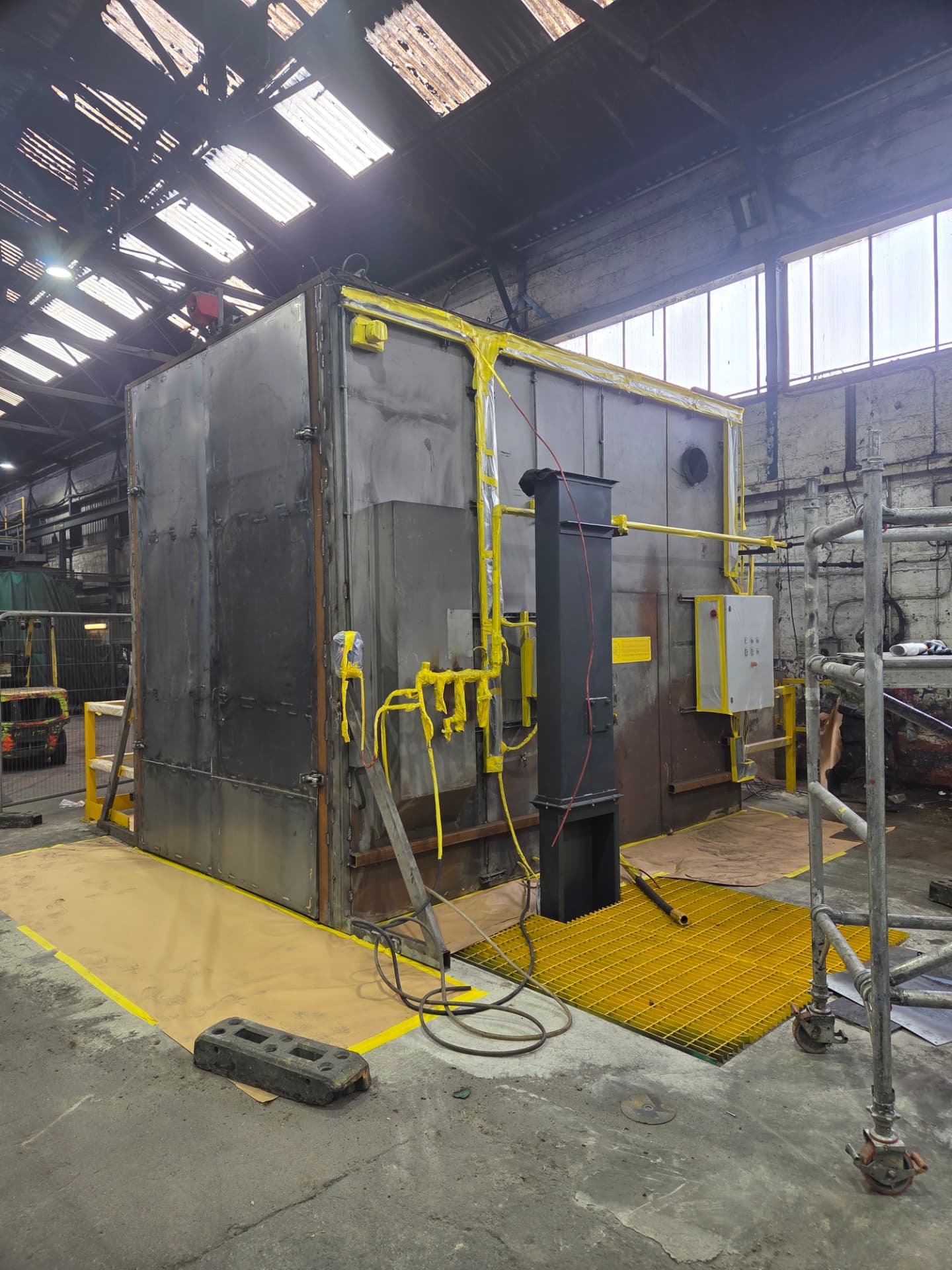 Company-supplied Forged Solutions photograph showing masking, scaffolding and floor protection during preparation