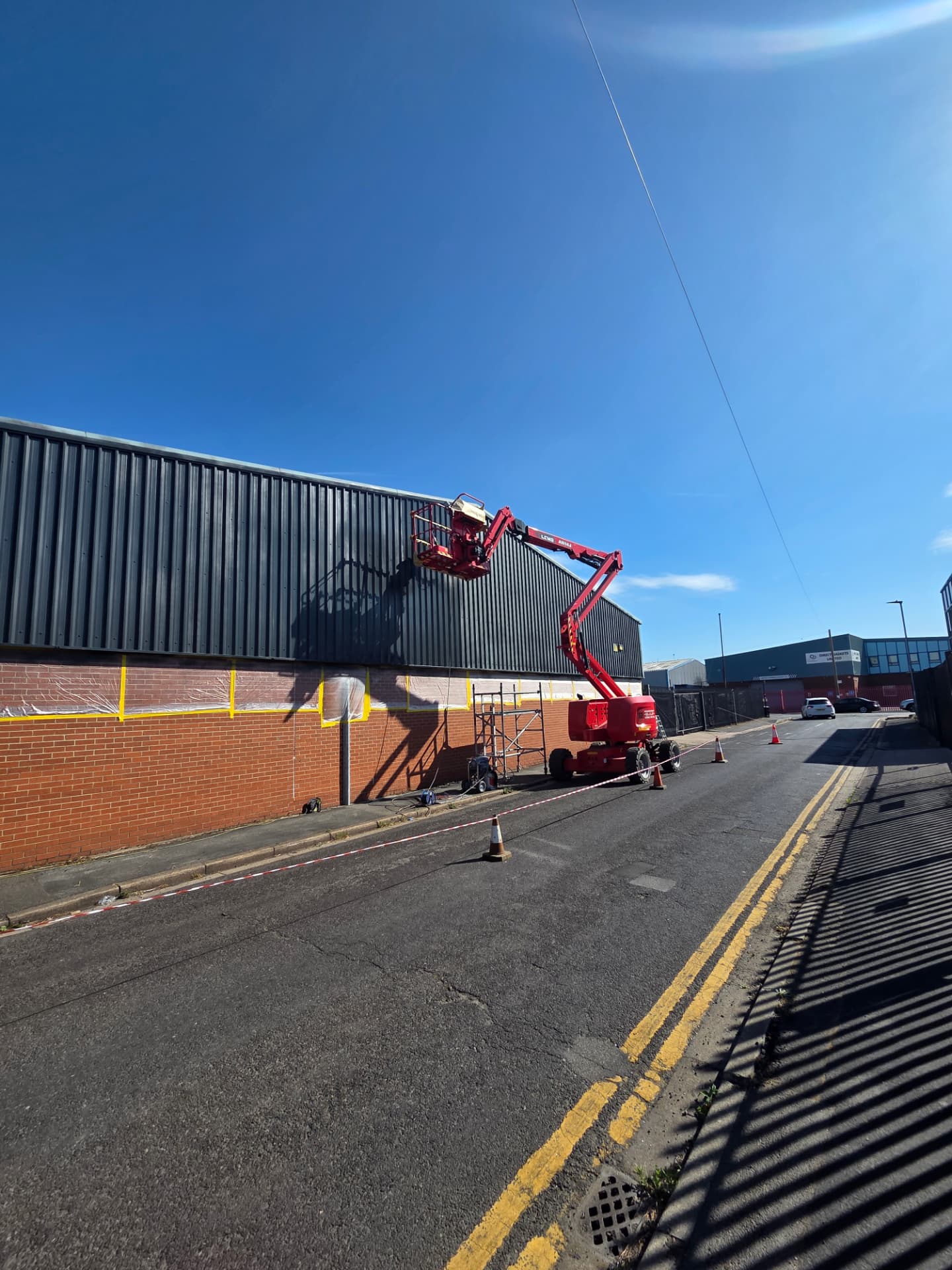 Company-supplied photograph of the cladding being resprayed from an access platform