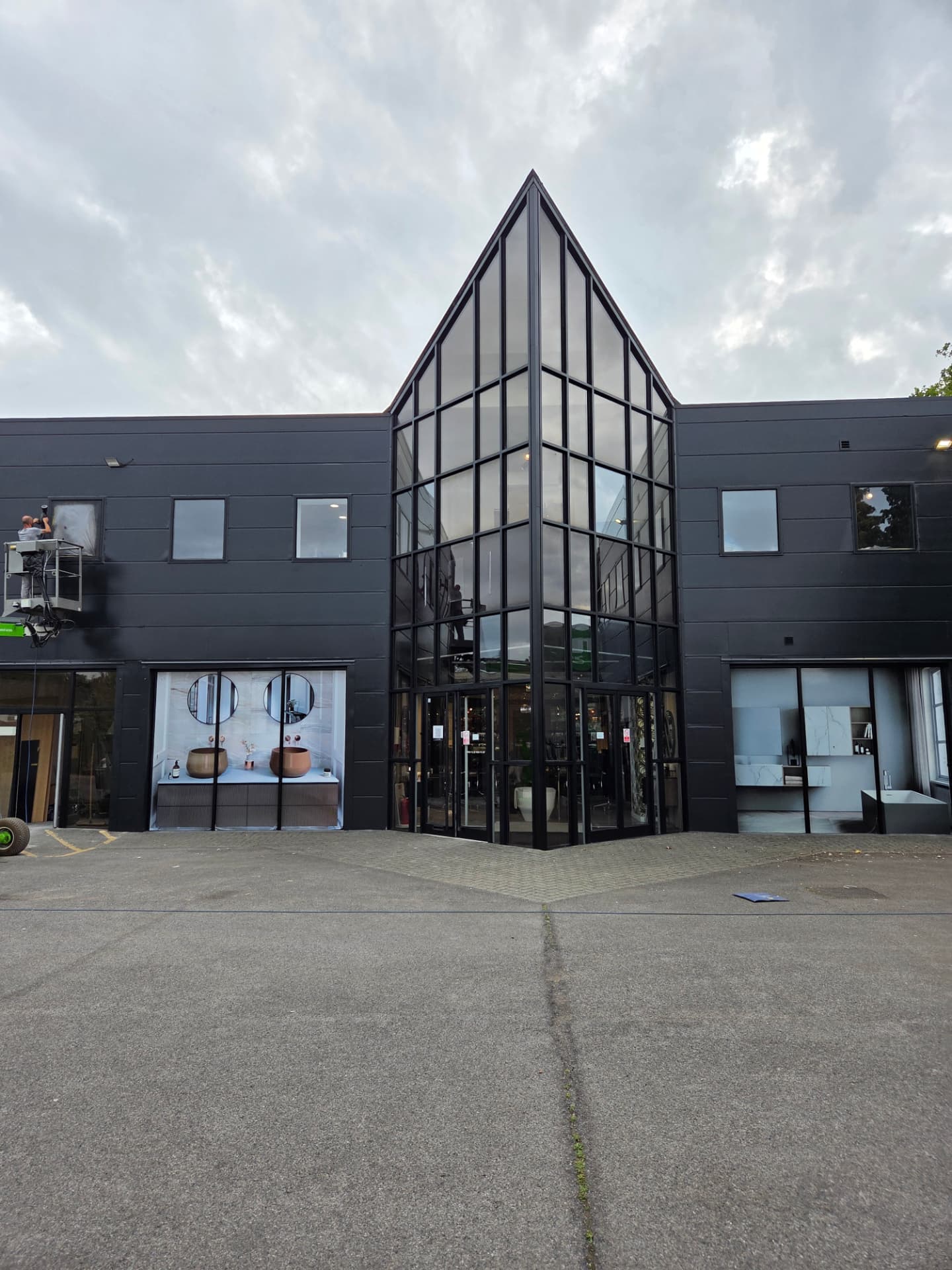 Company-supplied photograph of the showroom with resprayed black cladding and the atrium glazing revealed