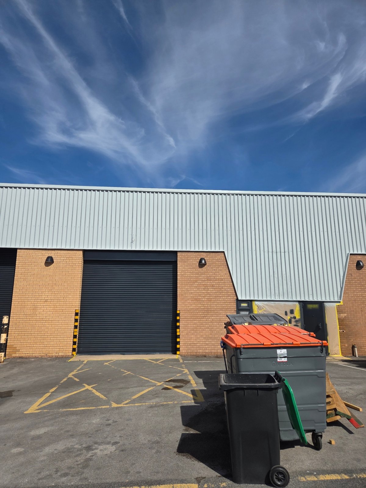 Company-supplied photograph: Bradford loading bay with anthracite grey shutter and masking remaining beside light grey cladding