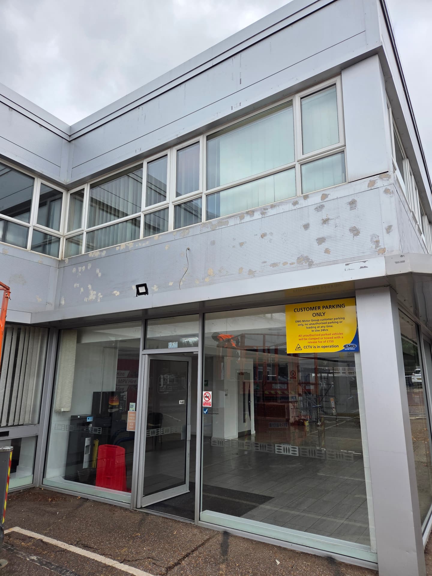 Company-supplied photograph of the original light grey Ford showroom entrance and cladding in Peterborough