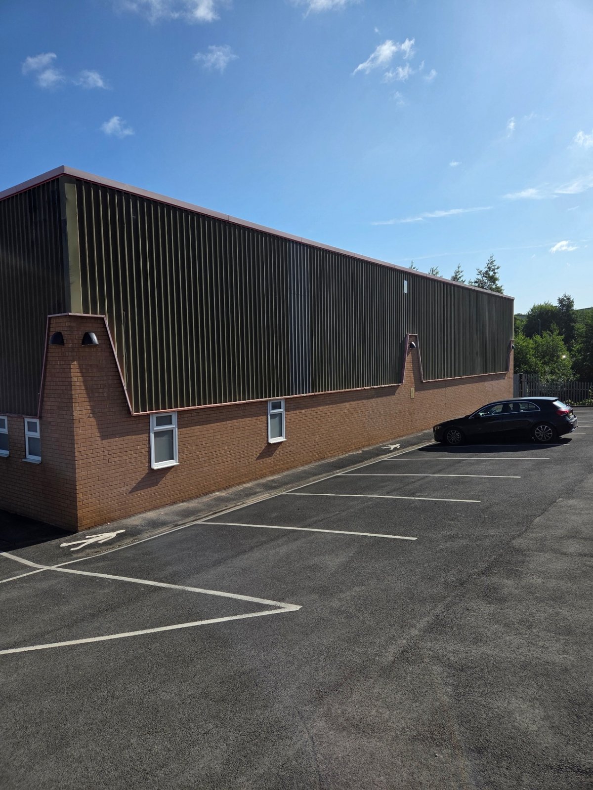 Company-supplied photograph: Bradford side elevation with original dark cladding before respraying