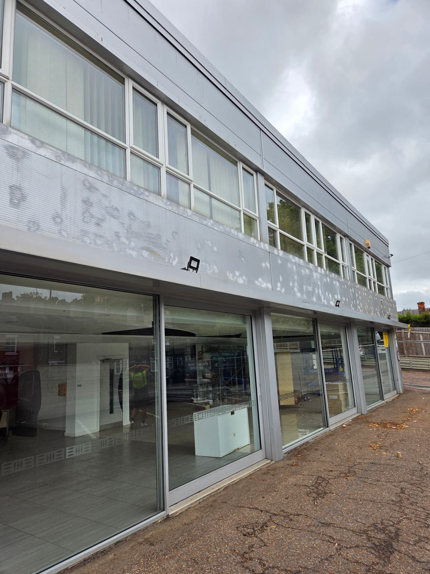 Company-supplied photograph: Ford showroom in Peterborough before respraying, showing original light grey cladding and windows