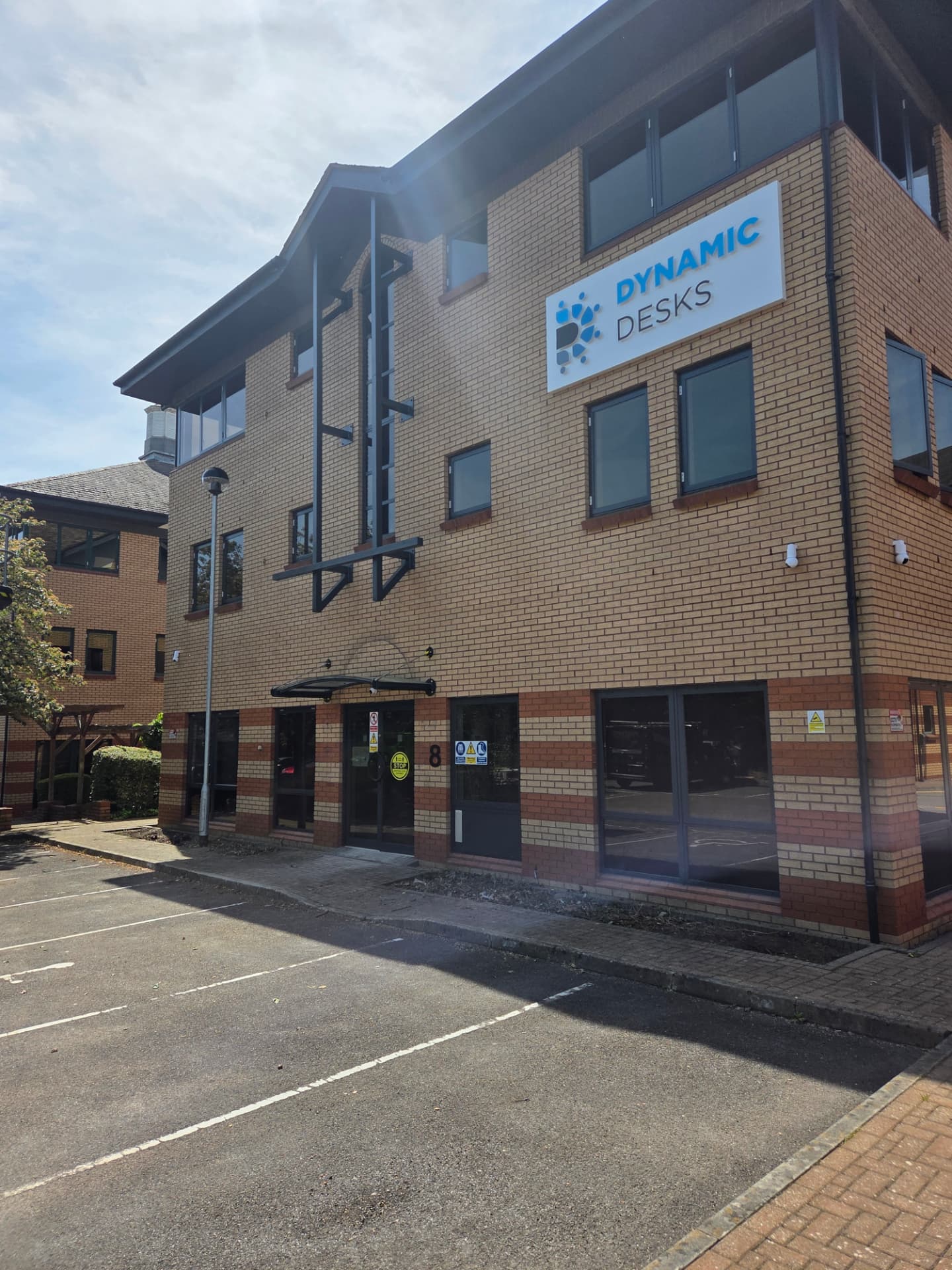 Company-supplied photograph of the Dynamic Desks entrance after windows and doors were resprayed in RAL 7016