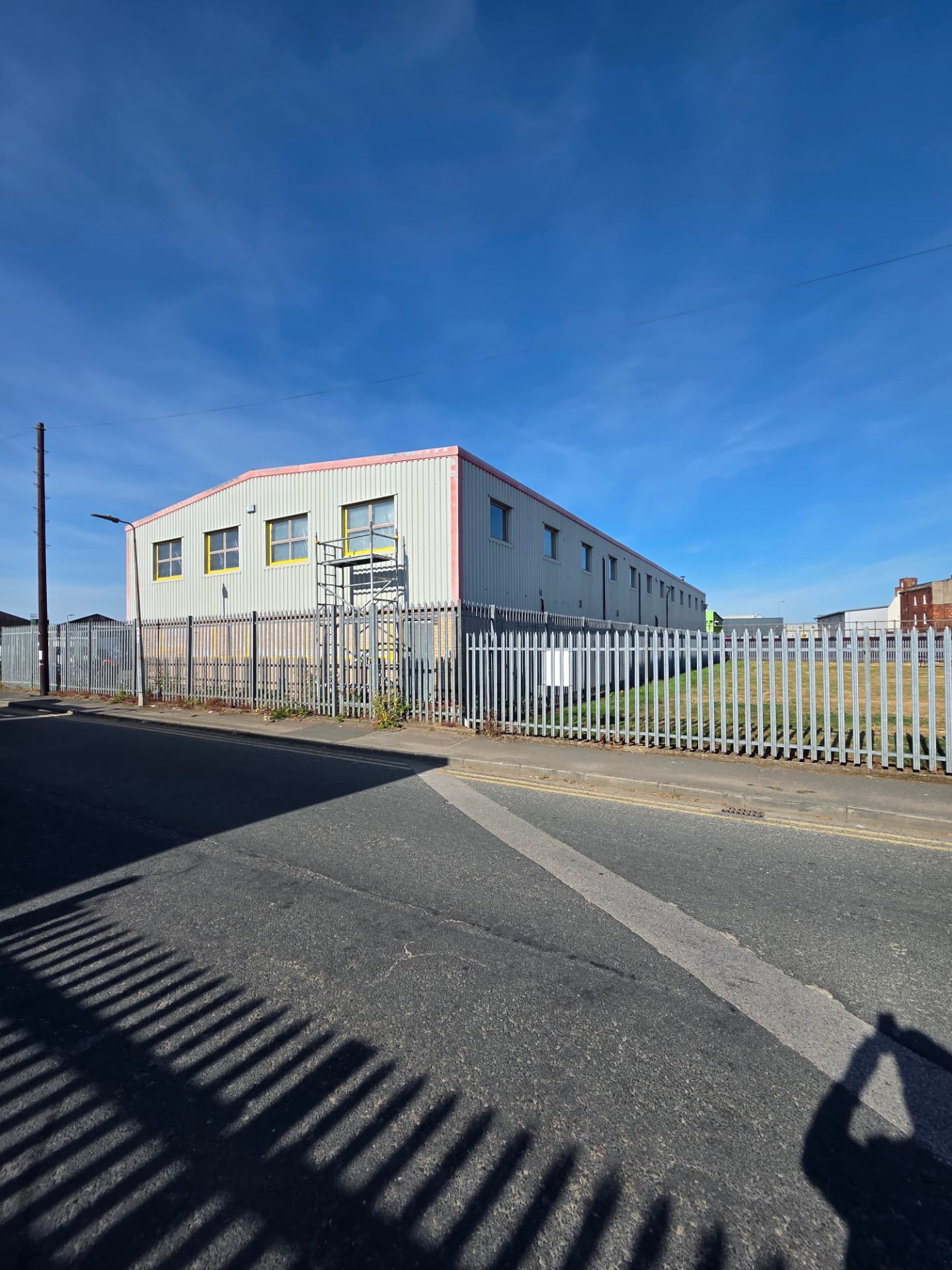 Company-supplied Hull process photograph showing protected windows and an access tower beside the end elevation