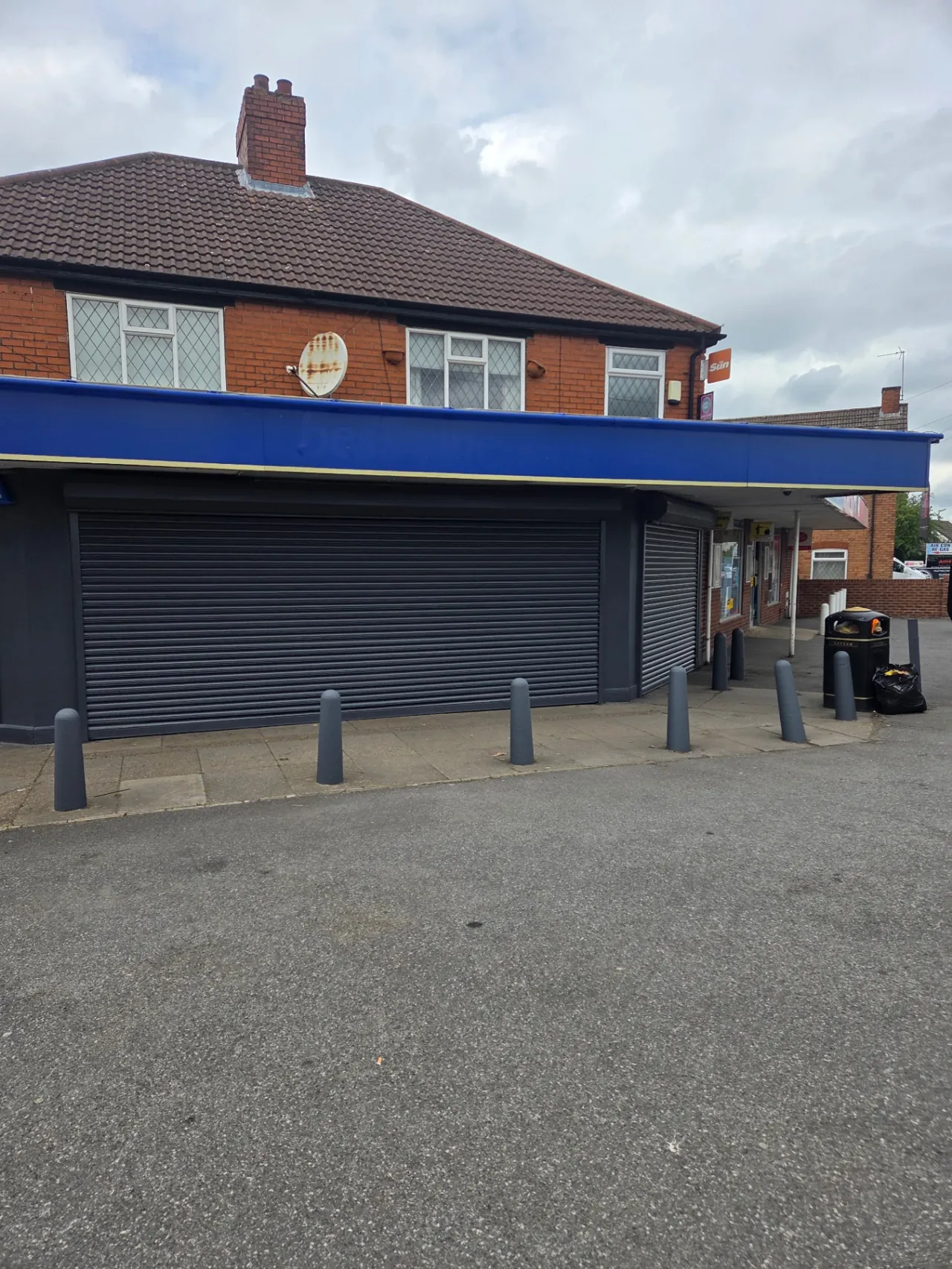 Company-supplied photograph of the completed best-one store frontage with dark grey shutters, framing and columns